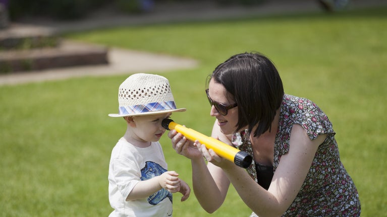 A child looking through a telescope at Sissinghurst